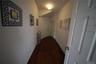 Corridor featuring baseboards, dark wood-style flooring, and radiator heating unit