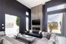 Living room featuring a towering ceiling and a fireplace