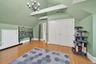 Bonus room with light wood-type flooring and a chandelier