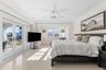 Bedroom with ornamental molding, french doors, a ceiling fan, access to exterior, and dark aggregate flooring