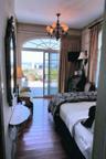 Bedroom with a chandelier, hardwood / wood-style floors, and multiple windows