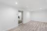Room in basement with view of washer/dryer