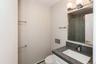 Bathroom with vanity, baseboard heating, and a tile shower