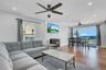Living area featuring a wood stove, healthy amount of natural light, recessed lighting, and wood finished floors