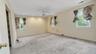 Empty room with ceiling fan, carpet flooring, and a healthy amount of sunlight