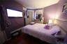 Bedroom featuring a wall mounted air conditioner and wood finished floors
