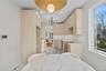 Bedroom featuring a chandelier, light marble finish floors, and recessed lighting