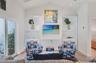 Living room showcasing the built in bookcases with the right bookcase being the hidden doorway to the primary suite