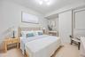 Bedroom with light wood finished floors and baseboards