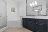 Two large vanities with wood cabinetry and stainless steel fixtures.