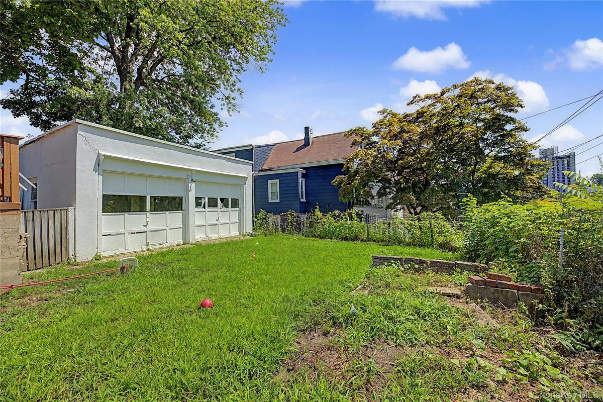 Detached two-car garage with overhead doors featuring multiple window panes