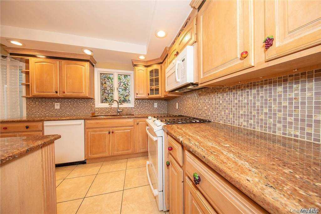 Granite counter tops, Dishwasher, stove and oven, microwave, tile backsplash, tile flooring.