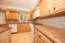 Granite counter tops, Dishwasher, stove and oven, microwave, tile backsplash, tile flooring.