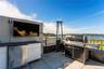 View of rooftop terrace with an outdoor kitchen and a water view