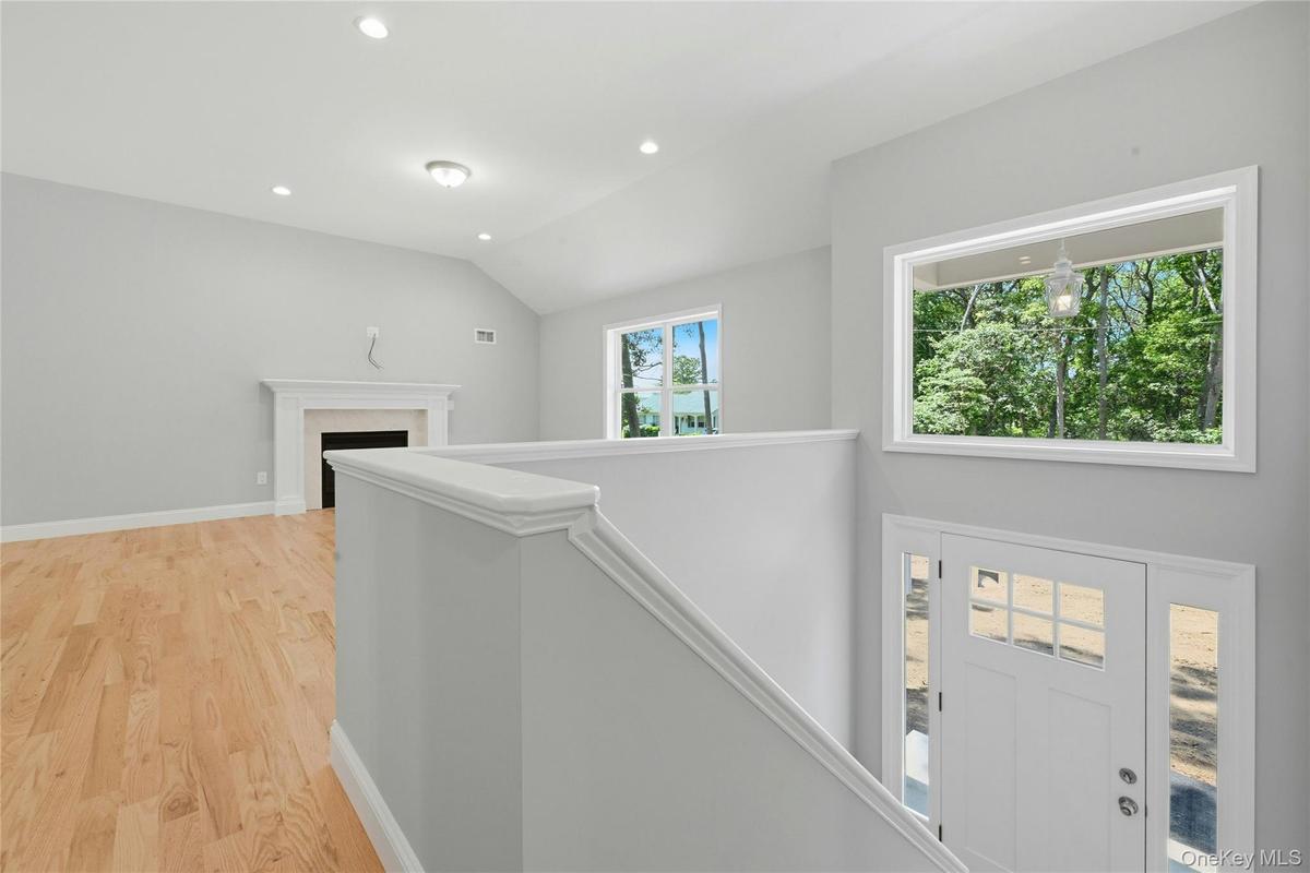 A large picture window above the entry door fills the foyer with an abundance of natural light.