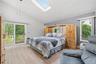 Primary Bedroom with SkyLight, Full Bathroom and Sliding Door to Deck