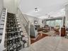 View from the entry foyer thru to the living room and stairs leading to bedroom level.