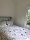 Bedroom featuring a decorative wall