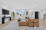 Recessed lighting, light wood-finish flooring, multiple windows, a modern entryway door, and a staircase with an iron baluster