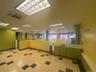 Kitchen with green cabinetry, light countertops, light floors, and a drop ceiling