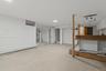 Finished basement with light floors and baseboard heating