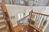 A view from the stairway landing looking to the foyer.