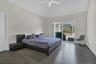 Bedroom featuring baseboards, a ceiling fan, lofted ceiling, wood finished floors, and access to outside