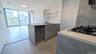Kitchen with open shelves, light countertops, a wall of windows, appliances with stainless steel finishes, and modern cabinets