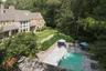 View of subject property with a pool area