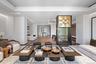 Living room with a raised ceiling, wood finished floors, and recessed lighting