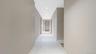 Hallway featuring light marble finish floors and recessed lighting
