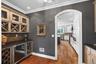 Butler's pantry with wine storage and fridge between kitchen/dining room