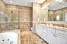 Second Floor Primary Bathroom en-suite featuring tile walls, double vanity, recessed lighting, a whirlpool tub, and a tile shower