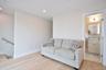 Living area with light wood-type flooring and recessed lighting