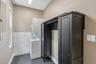 Stackable washer & dryer located next to the kitchen