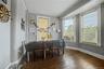 Hardwood flooring, multiple windows, window air conditioning unit, built-in shelving, crown molding
