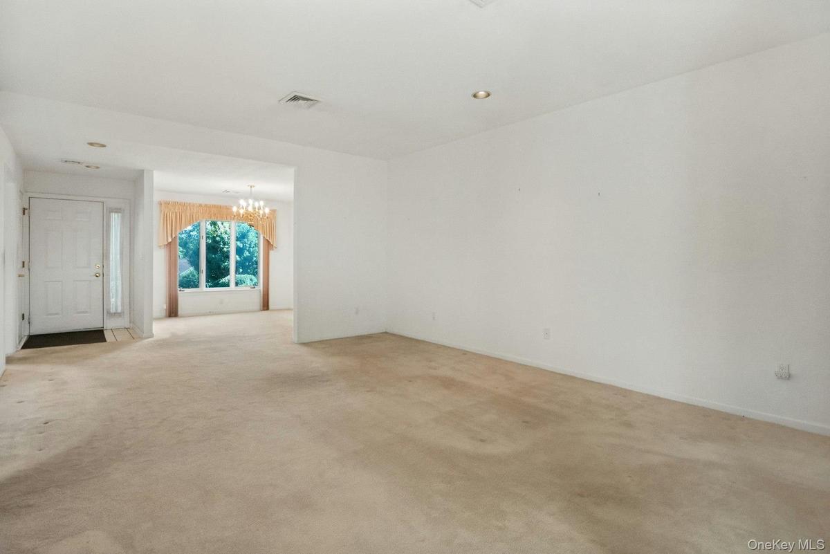 Long view of the living room to the dining area, & entry hall