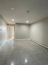 Empty room with a baseboard radiator and recessed lighting