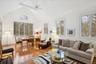 Living room with a healthy amount of sunlight, ceiling fan, high vaulted ceiling, and light hardwood / wood-style floors