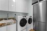 Laundry room with a sink and an extra refrigerator!