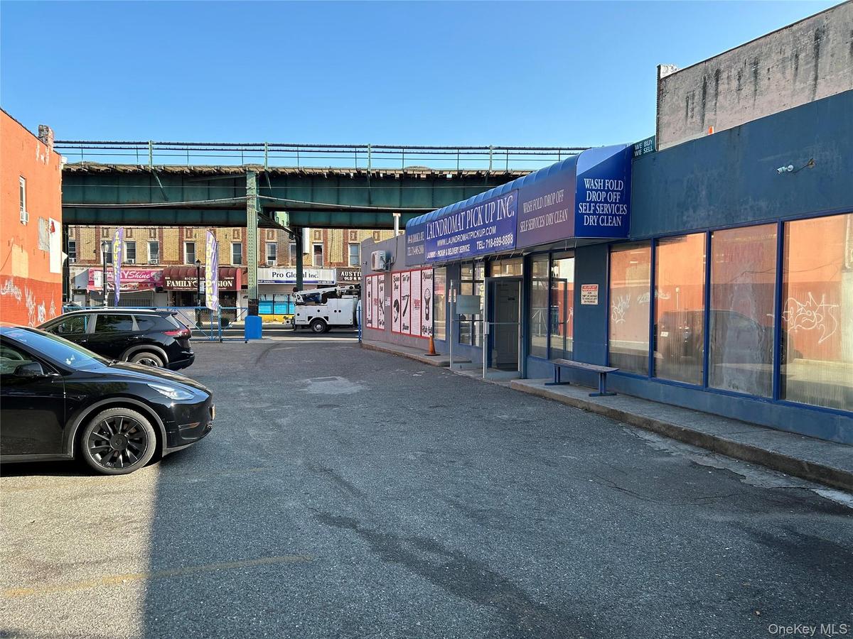View of commercial property with uncovered parking