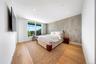 Bedroom featuring an accent wall, light wood finished floors, and recessed lighting