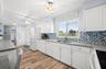 Kitchen has been updated with Glass tile backsplash and ample storage