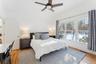 Bedroom with multiple windows  and  wood floors
