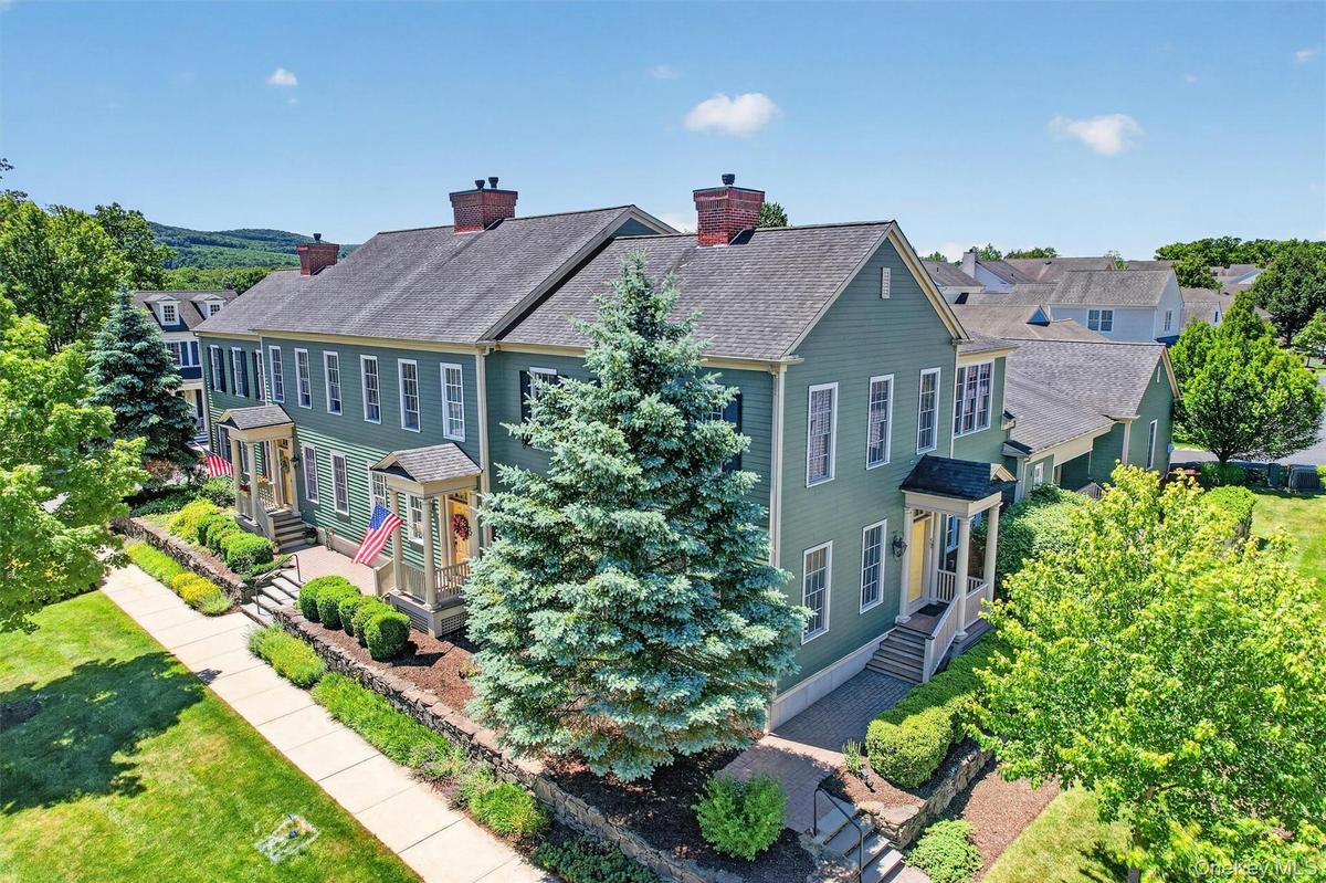 An elevated view showcases the charming landscape, manicured grounds, and thoughtfully designed setting that gives the Warwick Grove community its inv