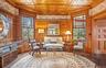 Living area with plenty of natural light, wooden ceiling, and wood finished floors