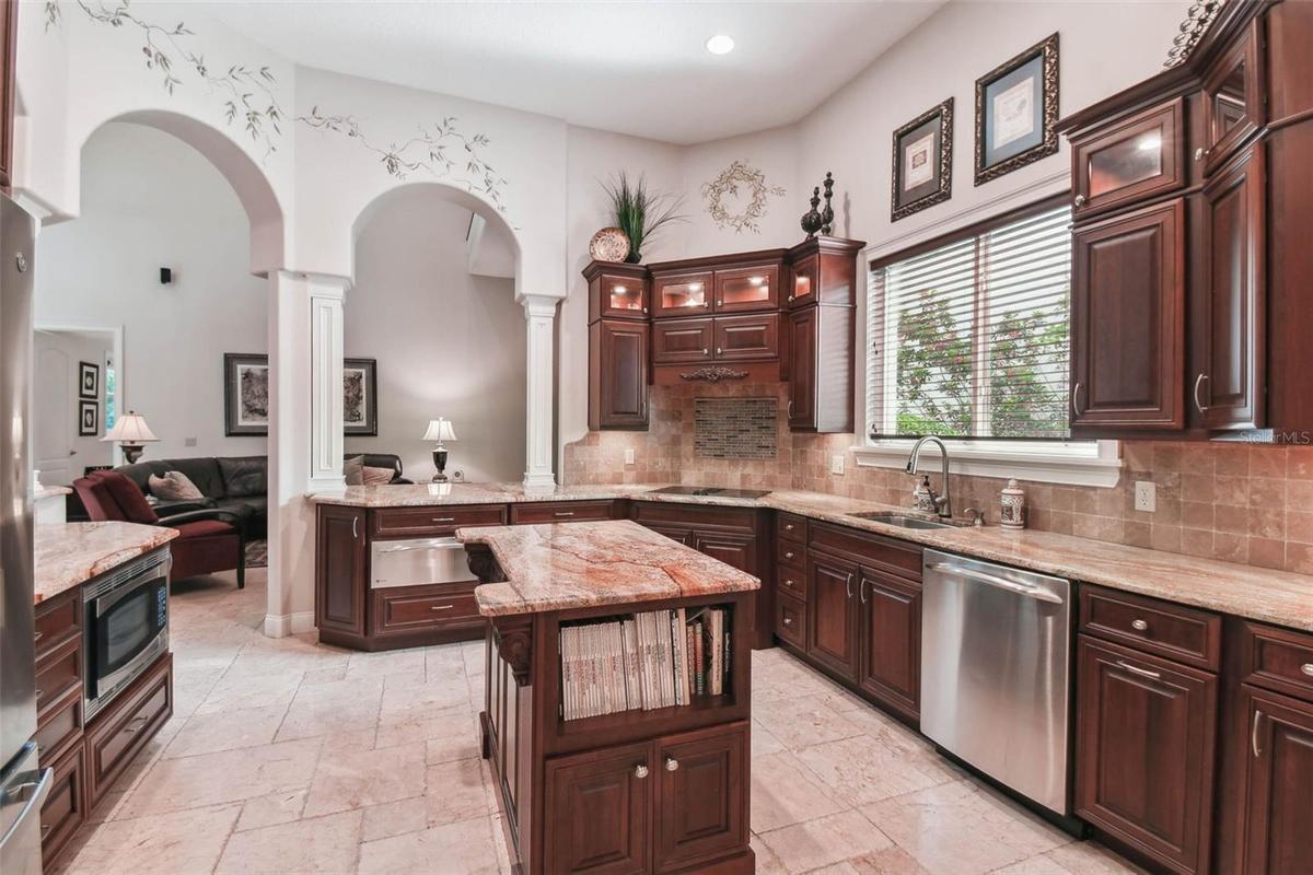 Archways connecting the kitchen to the family and dining rooms.