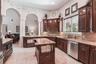 Archways connecting the kitchen to the family and dining rooms.
