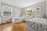 Bedroom featuring light wood-type flooring and ornamental molding