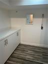 The Laundry room with hook ups (bring your own), folding counter and cabinetry.